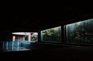 a dark room with a pool in the middle of it